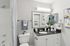 Bathroom with granite countertop vanity, mirror, toilet, and shower tub combination