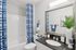 Bathroom with granite countertop vanity, mirror, toilet, and shower tub combination