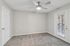 Empty bedroom with ceiling fan, carpet flooring, and sliding door access to outdoor patio
