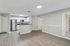 Open living and kitchen area with wood-style flooring and stainless steel appliances