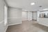 Open living and kitchen area with wood-style flooring and stainless steel appliances