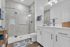 Bright and modern bathroom featuring a spacious glass-enclosed shower, elegant vanity with sleek fixtures, and stylish decor accents.
