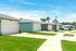 Charming suburban neighborhood design with modern single-story homes, pristine lawns, and a sunny sky.