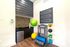Chic home gym corner with modern fitness equipment, vibrant exercise balls, and stylish geometric wall art.