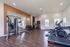 Modern gym with state-of-the-art fitness equipment, including treadmills, weight machines, and a bright, open layout.