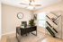 Elegant home office with modern desk, stylish geometric bookshelf, and large window for natural light.