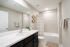 Chic and modern bathroom with elegant vanity, polished fixtures, and inviting bathtub for a relaxing retreat.