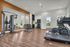 Modern fitness center with state-of-the-art equipment, vibrant design, and large windows for natural light.