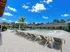 Luxurious poolside retreat with elegant loungers and tropical palm trees under a vibrant blue sky.
