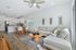 Contemporary open-concept living and dining area with sleek hardwood floors, cozy sectional sofa, and a stylish kitchen with modern appliances.