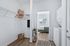 Bright and inviting laundry area with modern washer, adjacent to a cozy bedroom with soft natural light.
