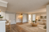 Inviting open-concept living room with elegant decor, featuring a cozy sofa and a stylish coffee table. Natural light highlights the modern design and warm tones.