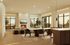 Spacious living room at Leawood Village Apartments offering a seamless blend of modern design and comfort. The room features a large sectional sofa, a stylish dining area, and expansive windows that provide stunning views of the outdoors and fill the space with natural light.