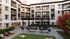 Spacious pool courtyard at Leawood Village featuring a modern pool design, lush gardens, and multiple seating areas for relaxation and social gatherings.