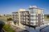 Modern apartment building exterior at The Lofts at City Center in Lenexa" Caption: "Contemporary design meets city center convenience