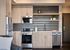 Modern kitchen with quartz countertops, stainless appliances, and designer tile backsplash