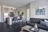 Open-concept living room and kitchen with modern furniture and finishes