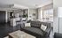 Contemporary living room with gray sofa and large windows