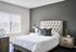 Spacious bedroom with modern furniture and ample natural light