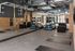 Functional training area with a pull-up rig, suspension straps, medicine balls, plyo boxes and floor mats