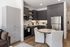 Apartment kitchen and dining area with a round table, upholstered chairs, a tall pantry cabinet and stainless appliances