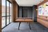 Game room with a wood table tennis table, tall windows, colorful abstract art and a drink ledge