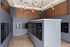 Mail and package room with wall-to-wall mailboxes, a central parcel locker island and pendant lighting