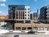Elevated view of The Wade's modern facade with an outdoor amenity terrace, street murals and the pool courtyard