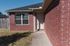 Inviting entrance of a charming red brick home with a welcoming front door.