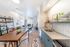 Bright and modern apartment interior with open-concept kitchen and living area, featuring sleek countertops, stylish furnishings, and abundant natural light.