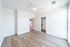Bright, spacious bedroom with elegant hardwood floors, a sleek ceiling fan, and ample closet space, perfect for modern living.