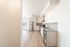 Bright and modern kitchen with sleek granite countertops, stainless steel appliances, and elegant hardwood flooring.