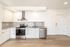 Modern kitchen with sleek stainless steel appliances, elegant countertops, and stylish cabinetry, perfect for gourmet cooking.
