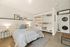Inviting bedroom with modern decor, cozy bedding, and convenient in-room laundry unit.