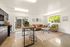 Bright and modern open-concept living area with chic kitchen, cozy seating, and abundant natural light.