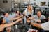 Vibrant outdoor gathering with friends enjoying drinks and laughter around a cozy fire pit.