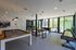 Chic communal game room with modern pool table, foosball, and shuffleboard, highlighted by stylish decor and vibrant seating.