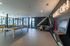 Modern recreational room with a pool table, arcade games, and 'Game On' neon sign, offering a vibrant social space.