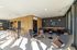 Bright and modern lounge area with sleek bar, stylish seating, and floor-to-ceiling windows creating an inviting atmosphere.