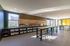 Bright and modern communal workspace with sleek design, ample storage, and natural light.