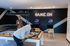 Modern game room with billiard table, arcade machines, and neon 'Game On' sign, creating an inviting social space.