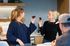 Modern kitchen setting with two women enjoying freshly baked brownies, highlighting social interaction and culinary delight.