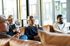 Modern apartment living room with large windows, cozy seating, and a welcoming atmosphere, perfect for social gatherings.