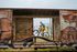 Biker riding through an abandoned train car with vibrant graffiti, blending adventure with artistic flair.