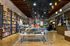 Vibrant bookstore interior with exposed brick walls, cozy wood shelves filled with colorful books, and inviting ambient lighting.