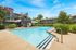 Inviting apartment complex showcasing a sparkling outdoor pool, surrounded by lush greenery and modern architecture, perfect for relaxation and leisure.