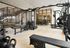 Modern fitness center featuring state-of-the-art weightlifting equipment, sleek design, and ample natural light.