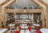 Chic and modern caf&eacute; interior with vibrant decor, cozy seating, and a welcoming atmosphere highlighted by natural wood accents and stylish lighting.
