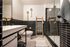 Contemporary bathroom with sleek black tile accents, modern fixtures, and a stylish glass shower.
