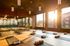 Inviting yoga studio with natural light, featuring wooden flooring, yoga mats, and props ready for a serene session.